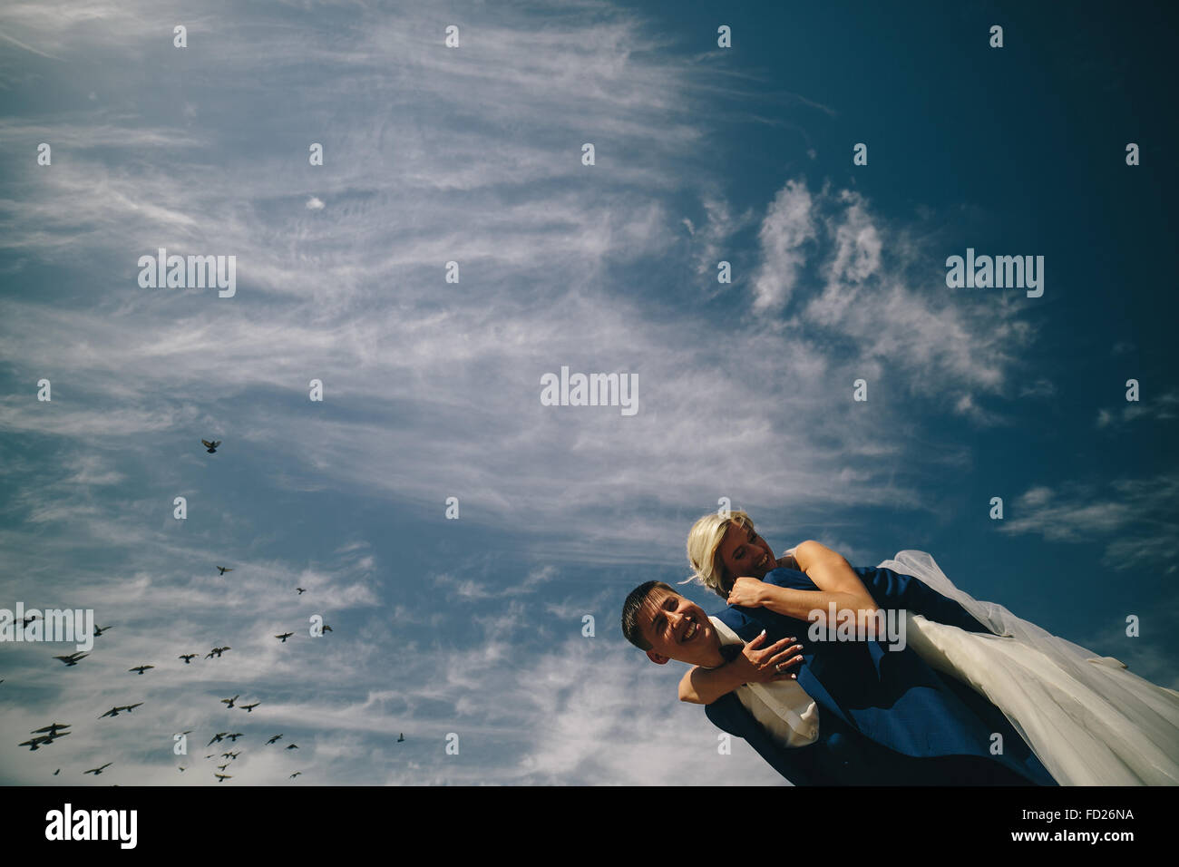 bride and groom on the background of sky Stock Photo - Alamy