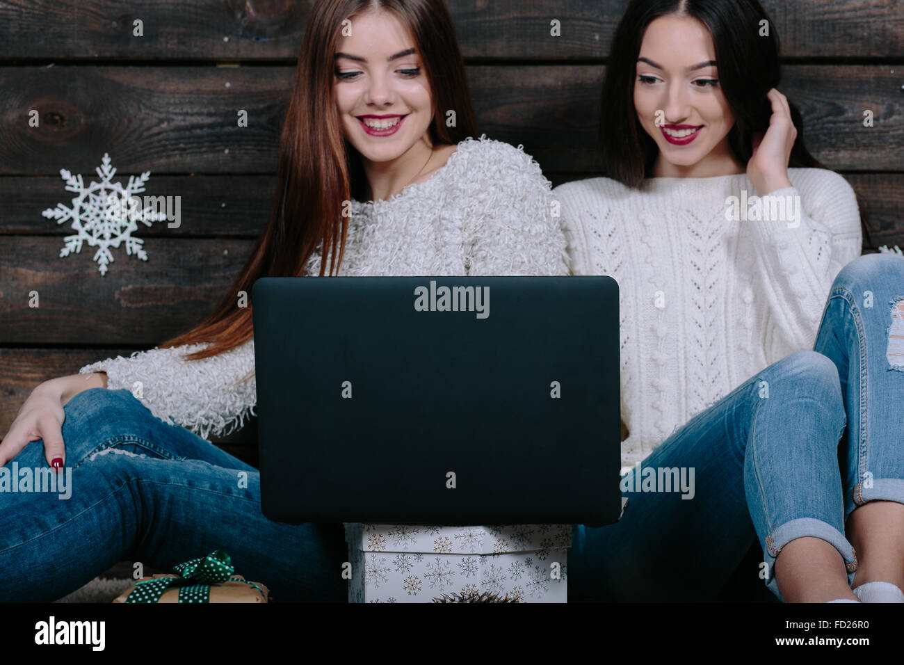 Two beautiful girls siting on the floor Stock Photo - Alamy