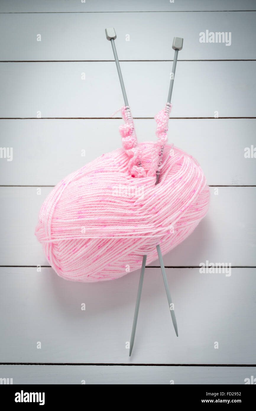 Knitting needles and a ball pink wool a knitting or needlework concept Stock Photo