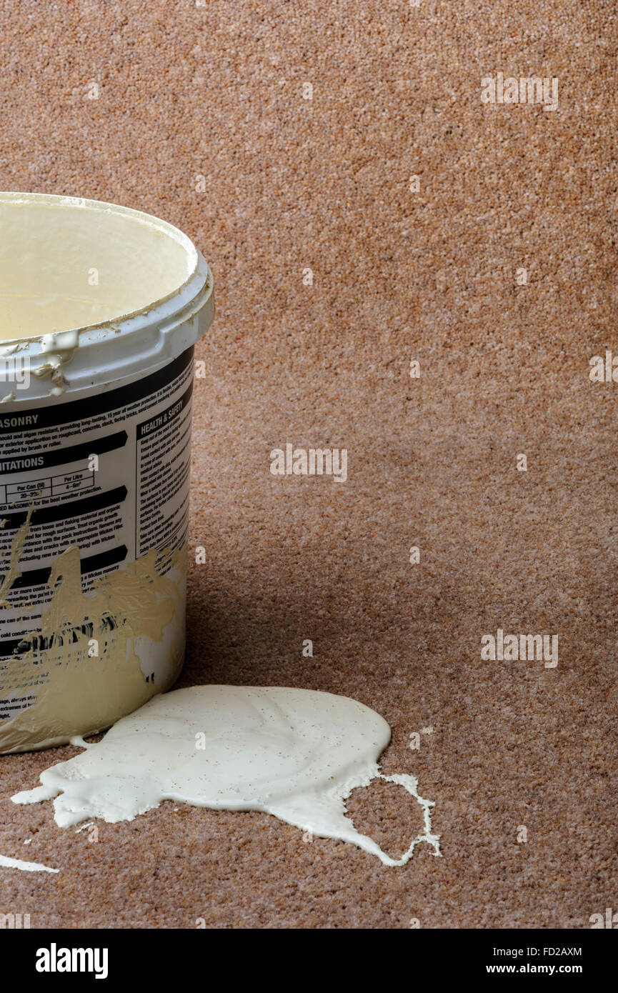Paint pot beside an accidental spill of paint. Stock Photo