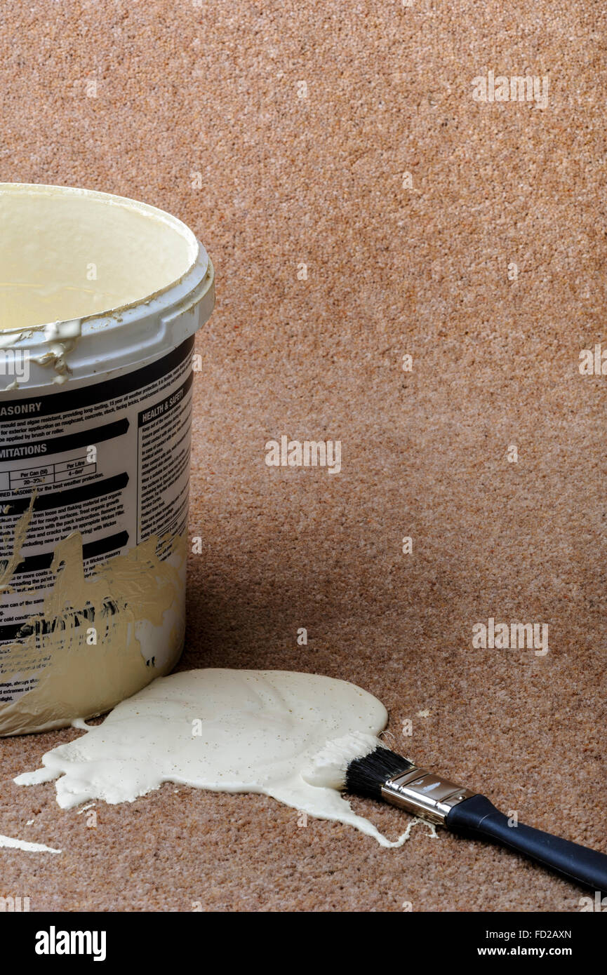 Paint pot and brush beside an accidental spill of paint. Stock Photo