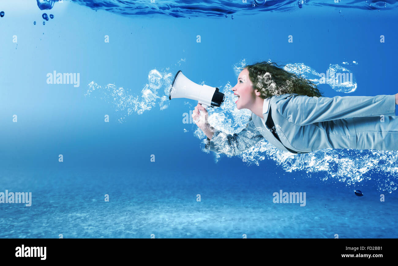 young-businesswoman-in-suit-swimming-in-crystal-blue-water-stock-photo