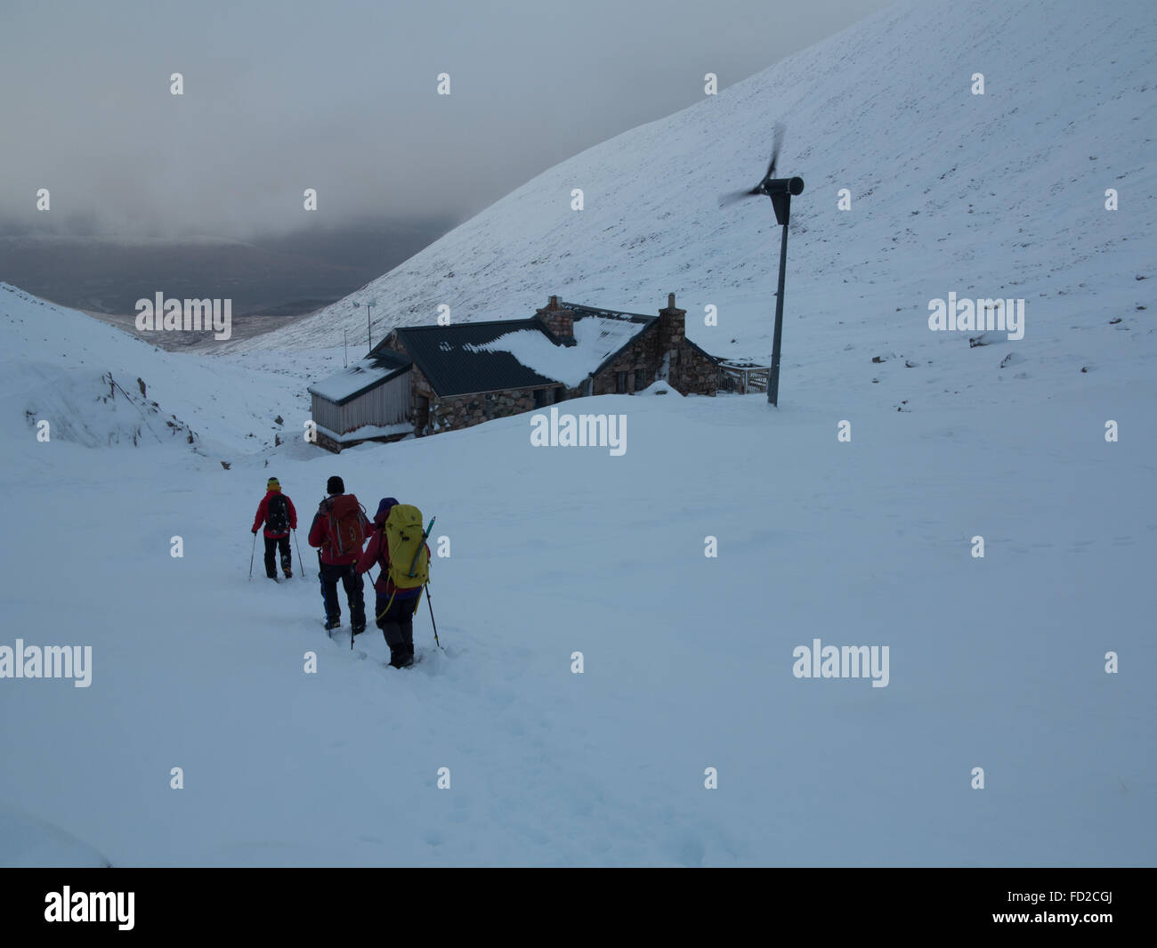 Mountaineers walk past the CIC mountaineering hut below the North Face of Ben Nevis near Fort William in the Scottish Highlands Stock Photo