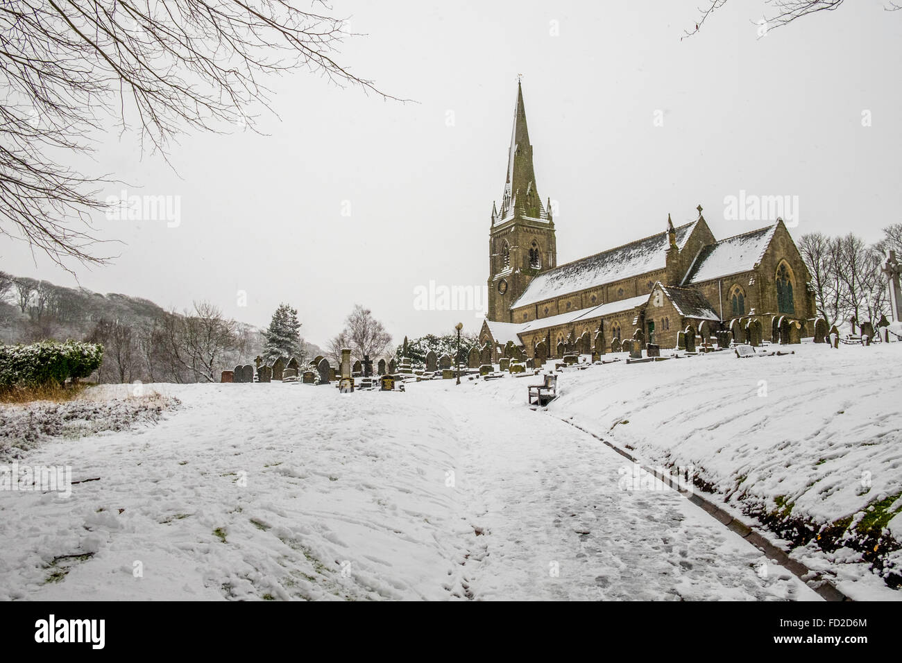 Going up the path leading up to a church with a snow covering the path and church in the distance Stock Photo