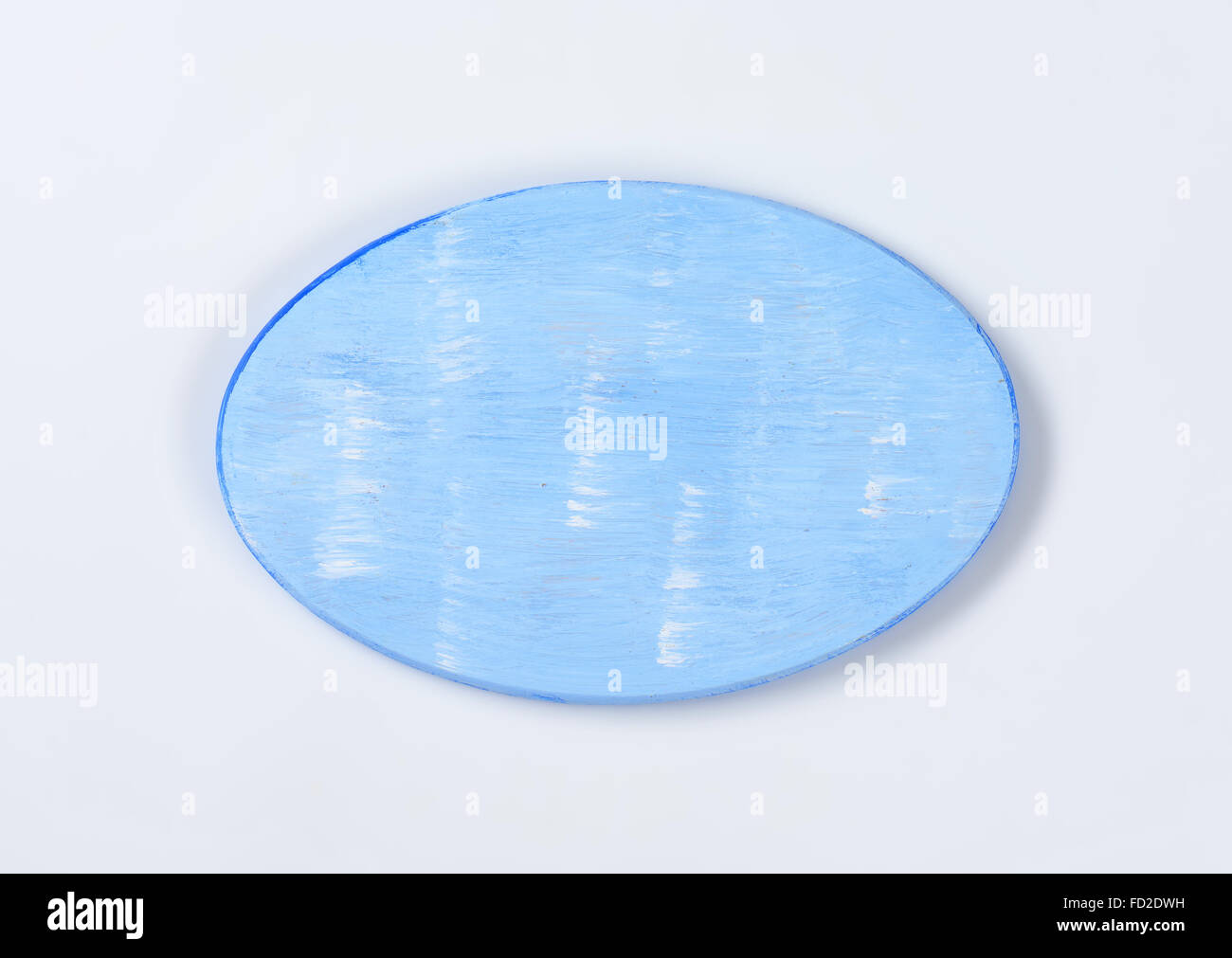 oval cutting board painted blue Stock Photo