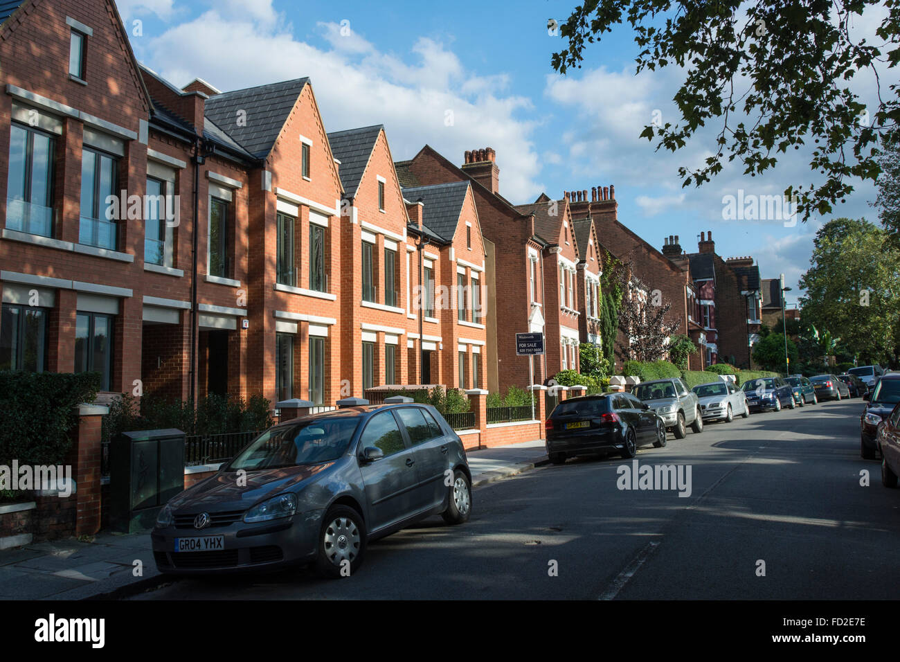 New houses at Calais Street, Myatts Field Park, Brixton, Lambeth, London – red brick terraced houses Stock Photo