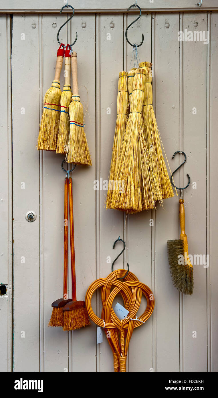 Brooms against a wooden door in France Stock Photo