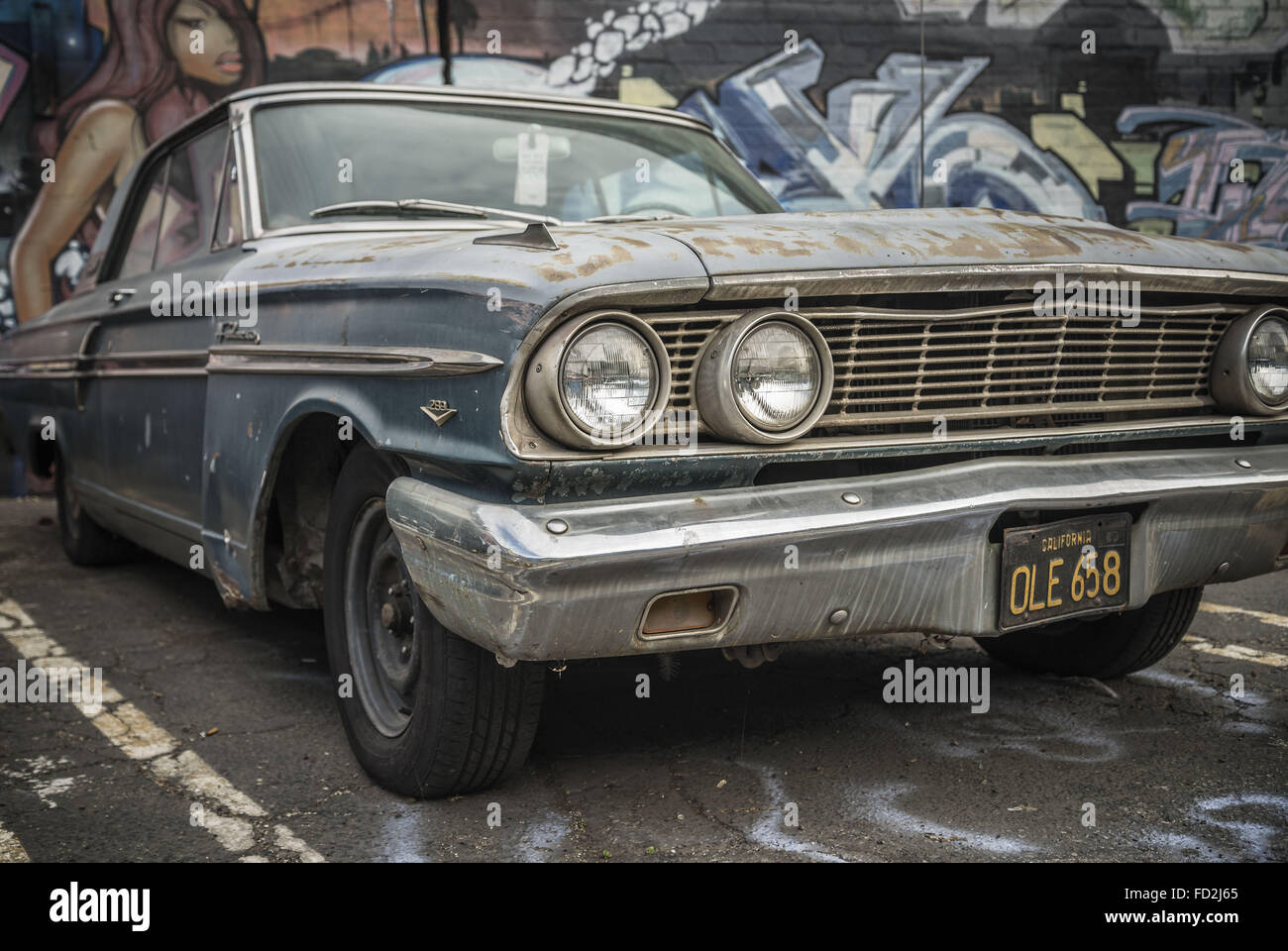 Los Angeles, California, USA. 9th Jan, 2015. A '65 Ford Fairlane sits in front of a mural-covered wall in the Arts District, Downtown LA. © Fred Hoerr/ZUMA Wire/Alamy Live News Stock Photo