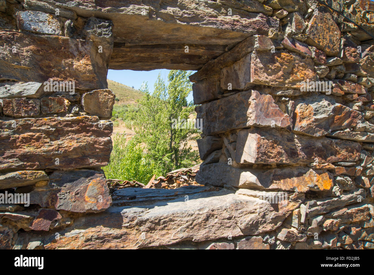 View through the window of a house in ruins. Patones de Arriba, Madrid province, Spain. Stock Photo