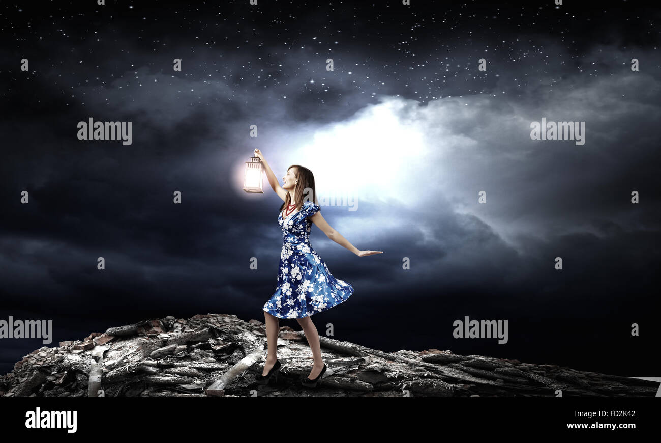 Young woman in blue dress with lantern Stock Photo - Alamy