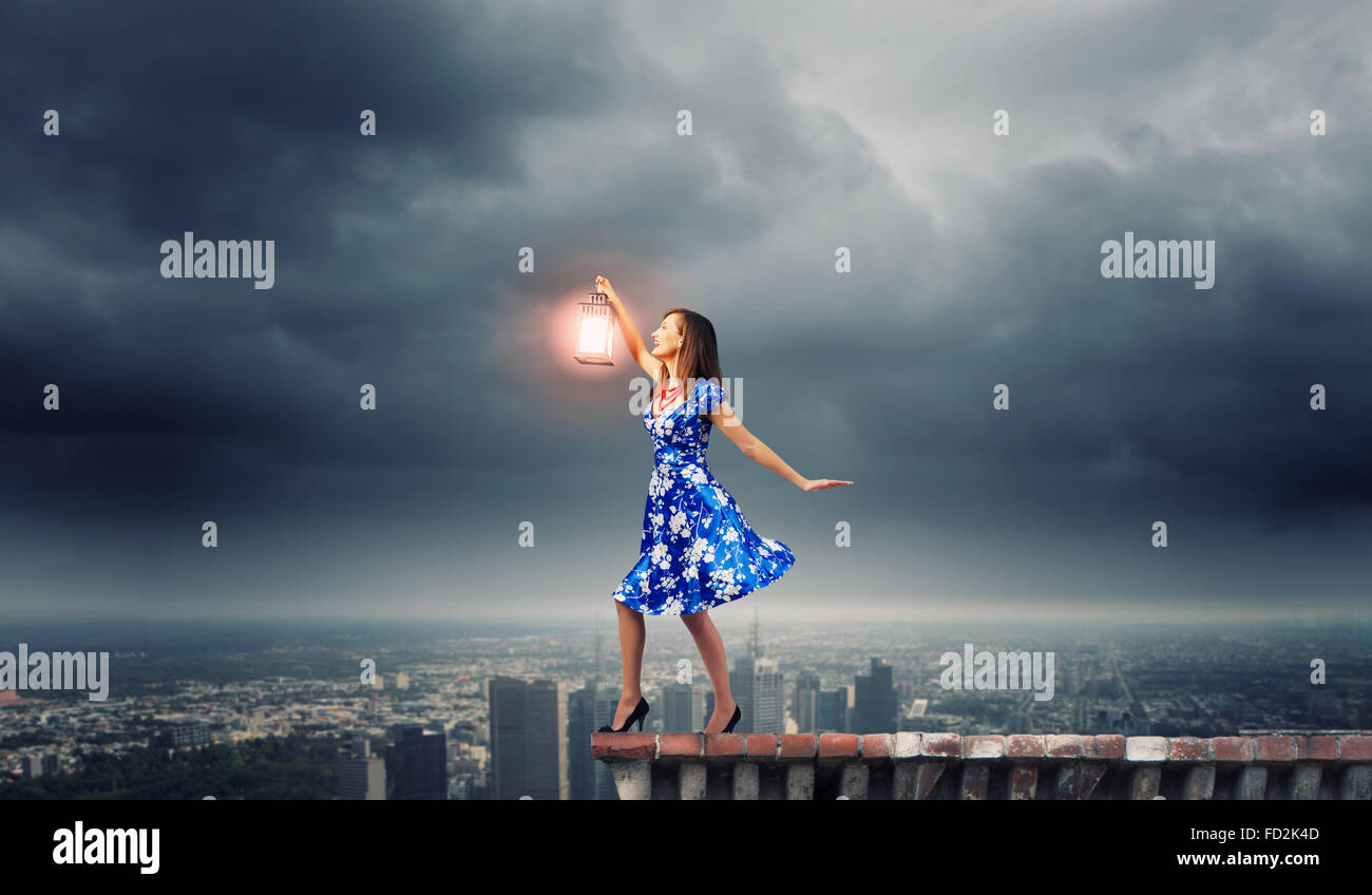 Young woman in blue dress with lantern Stock Photo - Alamy