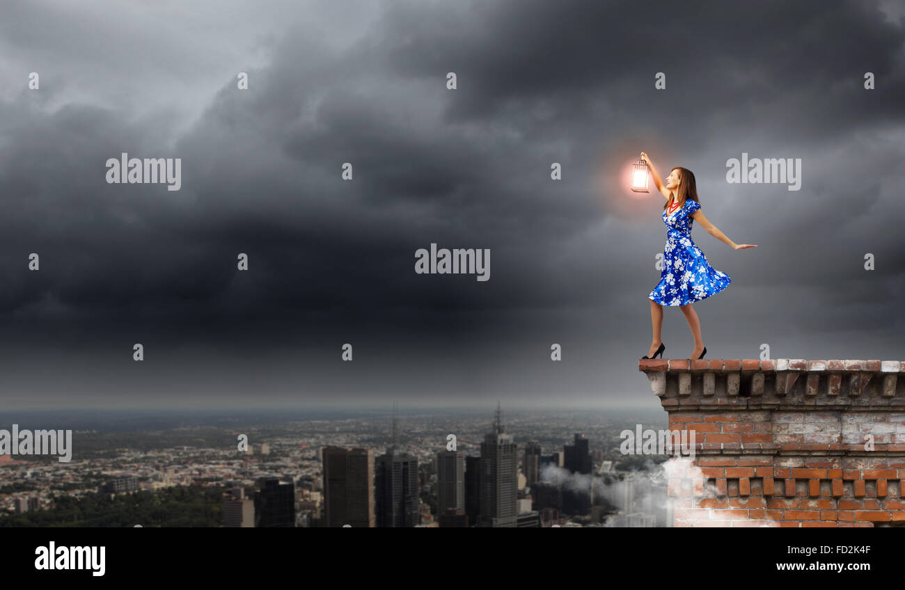 Young woman in blue dress with lantern Stock Photo - Alamy