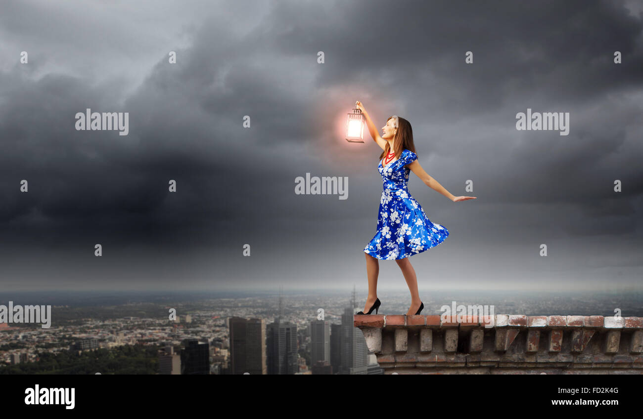 Young woman in blue dress with lantern Stock Photo - Alamy