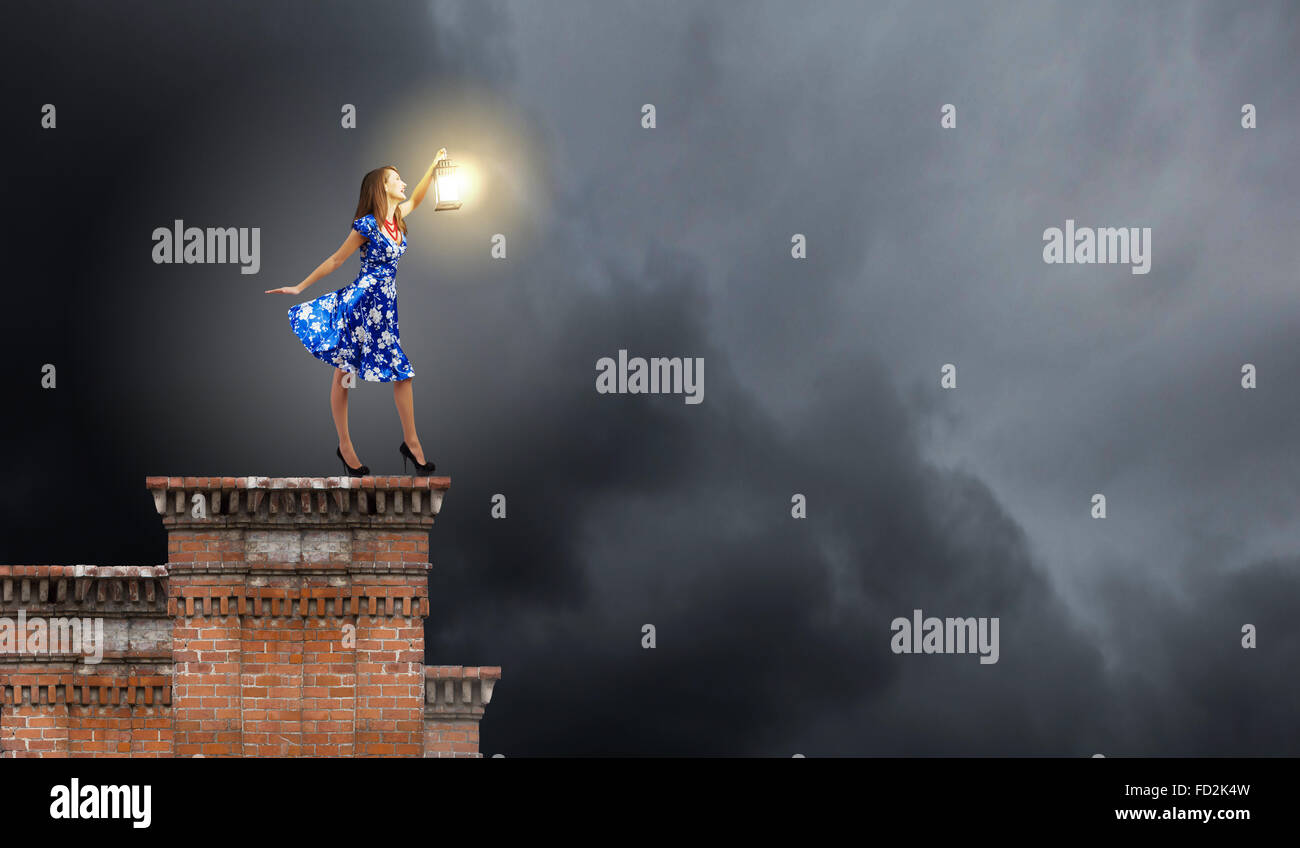 Young woman in blue dress with lantern Stock Photo - Alamy
