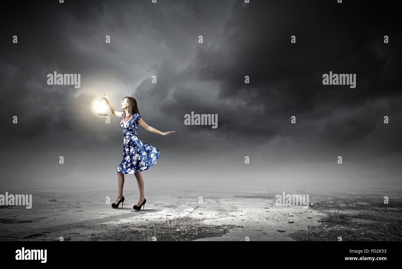 Young woman in blue dress with lantern Stock Photo - Alamy