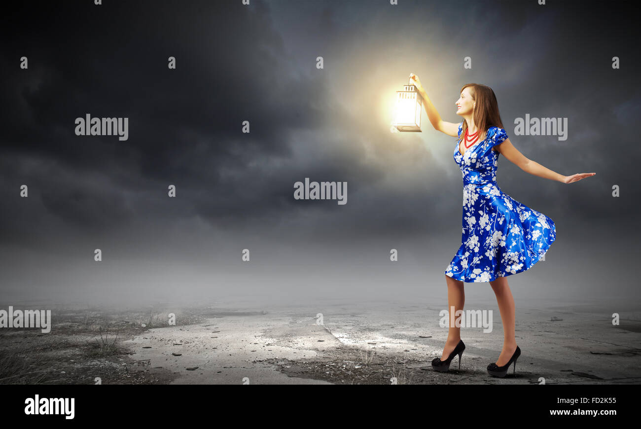 Young woman in blue dress with lantern Stock Photo - Alamy