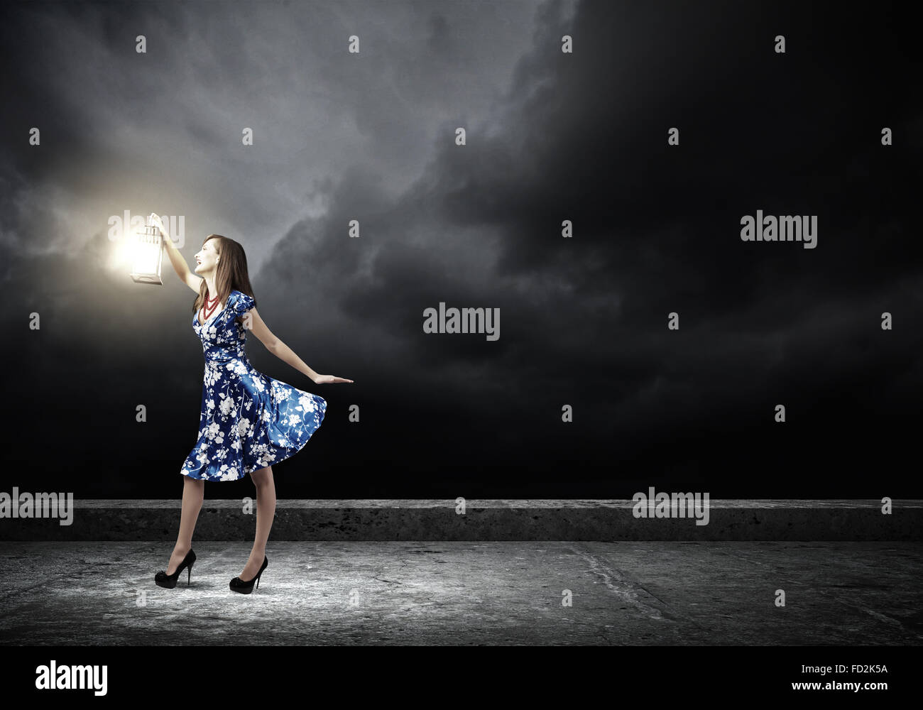 Young woman in blue dress with lantern Stock Photo - Alamy