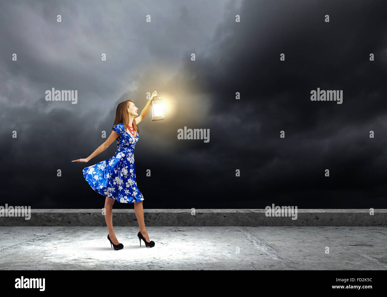 Young woman in blue dress with lantern Stock Photo - Alamy