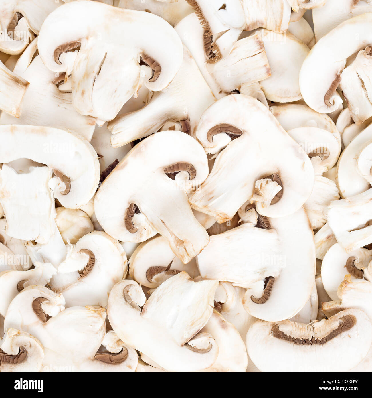 Champignon mushrooms sliced raw food pattern background Stock Photo