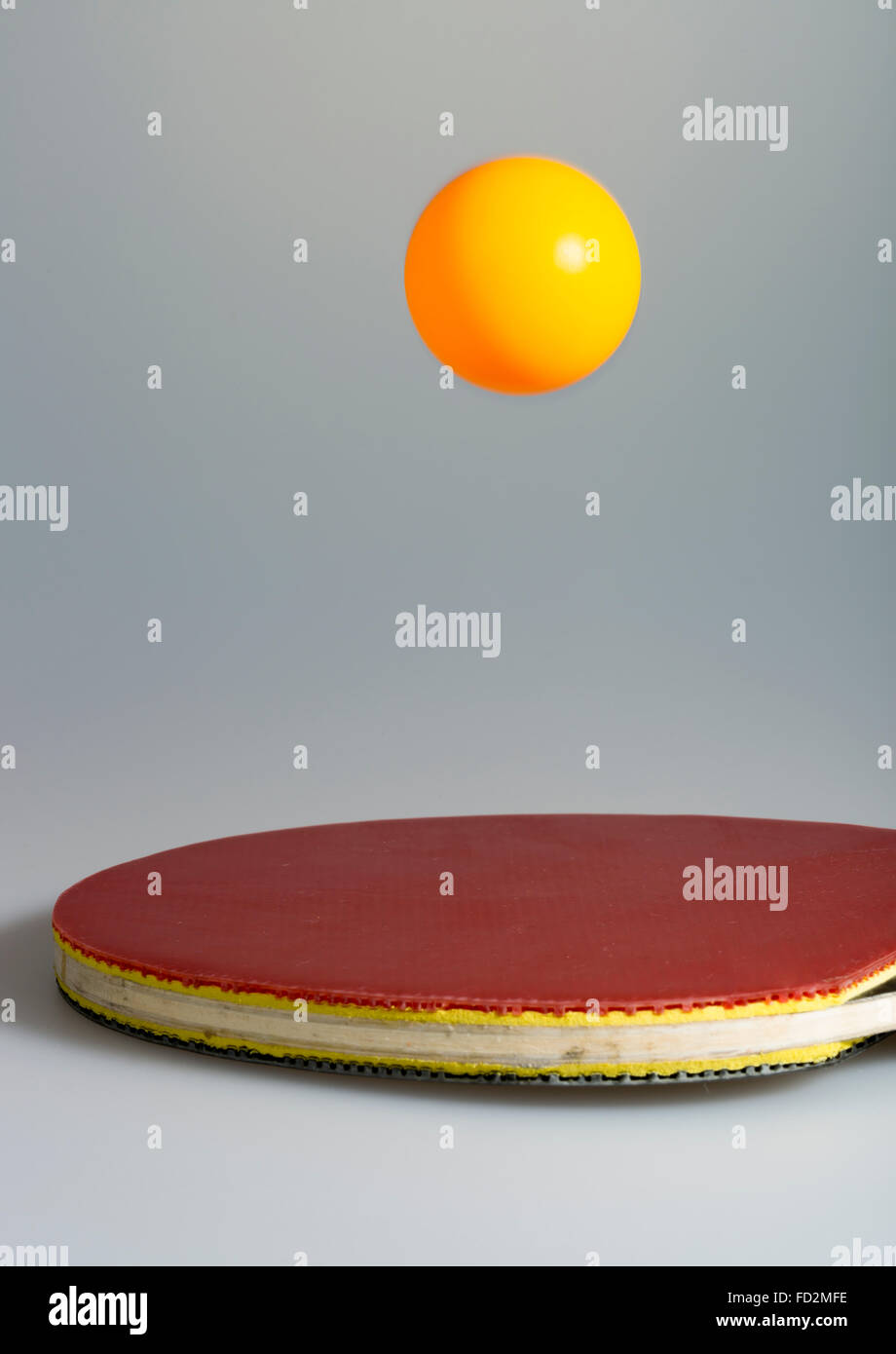 Table Tennis Ball and Paddle on grey background. Stock Photo