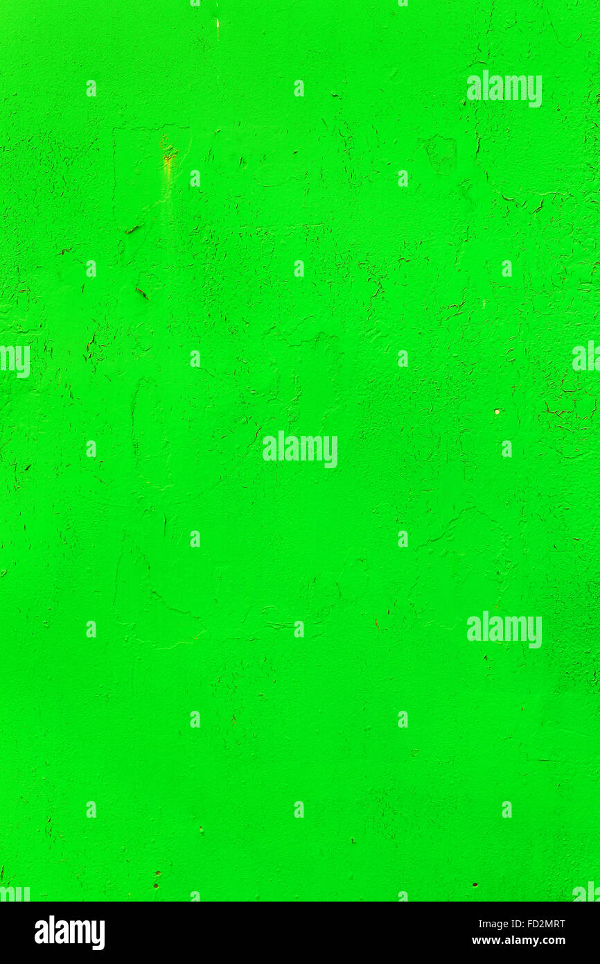 Bright background old damaged wall with cracks, scratches, painted with green paint. Textured background for your concept or pro Stock Photo