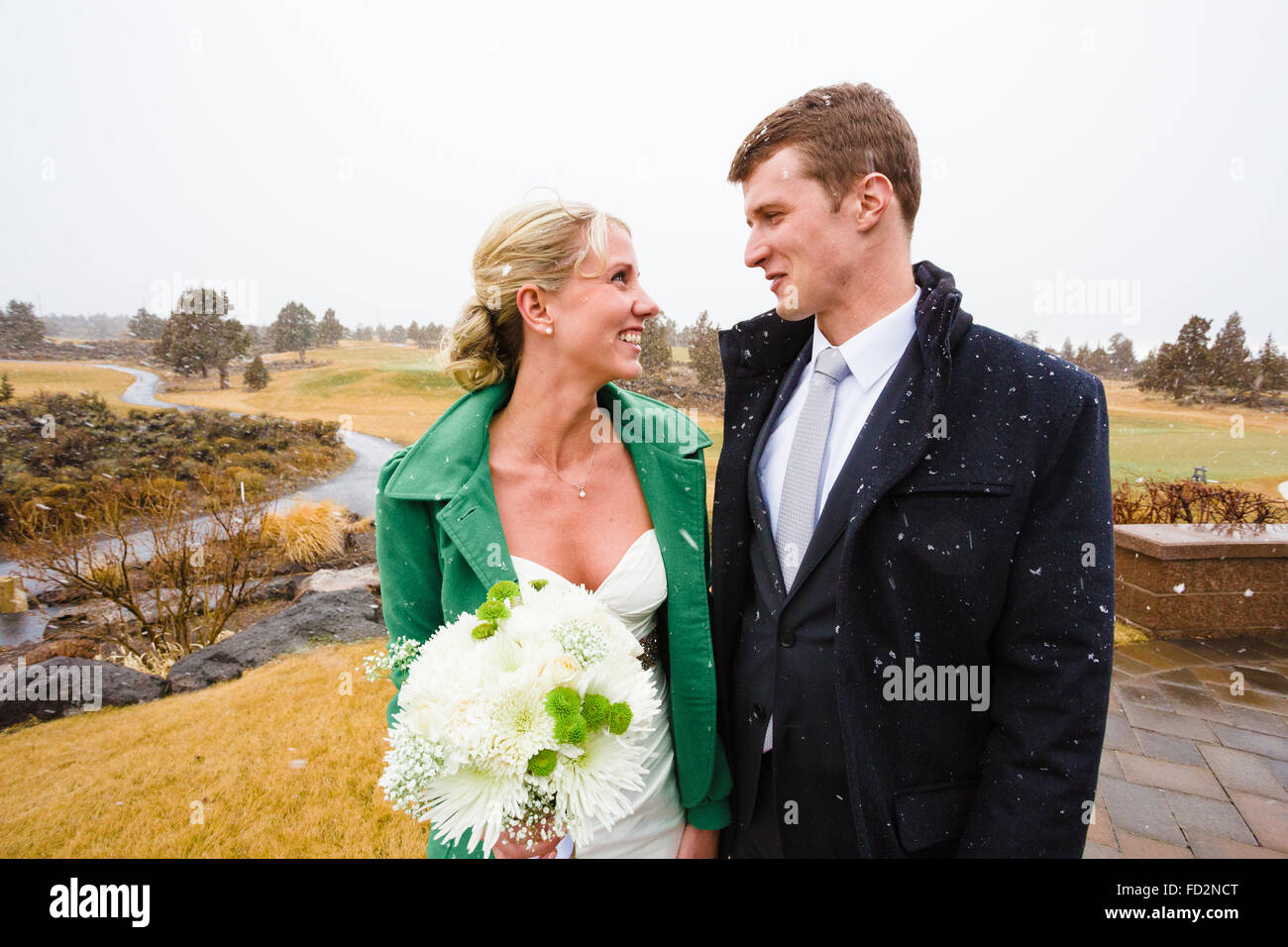 Winter portrait of a bride and groom in snow on their wedding day in Central Oregon. Stock Photo