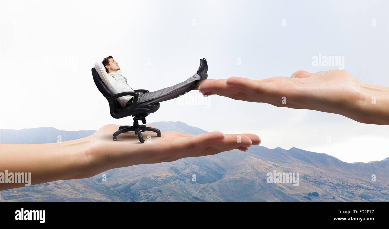 Young businessman sitting in chair with legs on table Stock Photo - Alamy