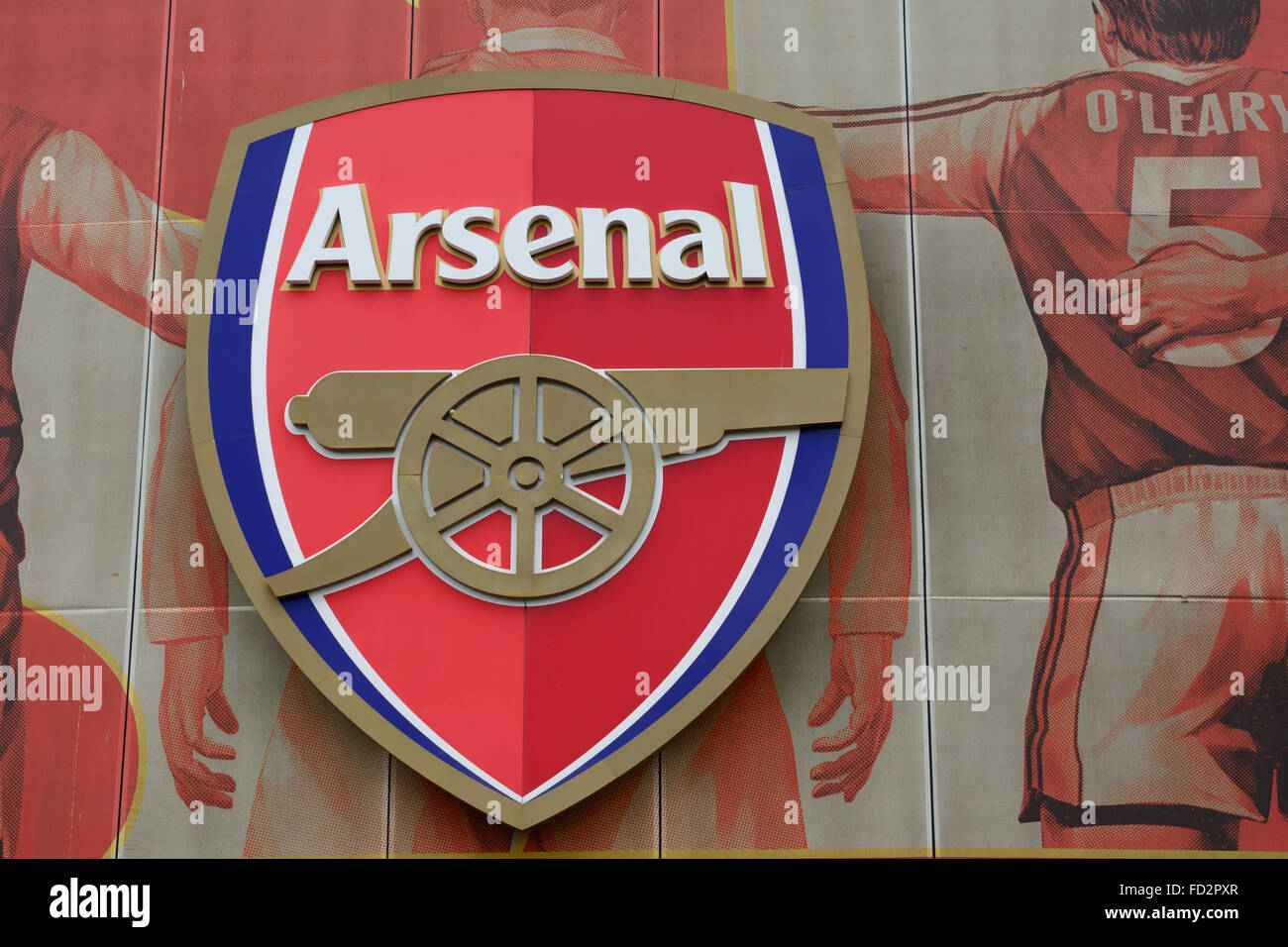 Arsenal logo on big poster with former star players on the outside of Emirates Stadium Stock Photo
