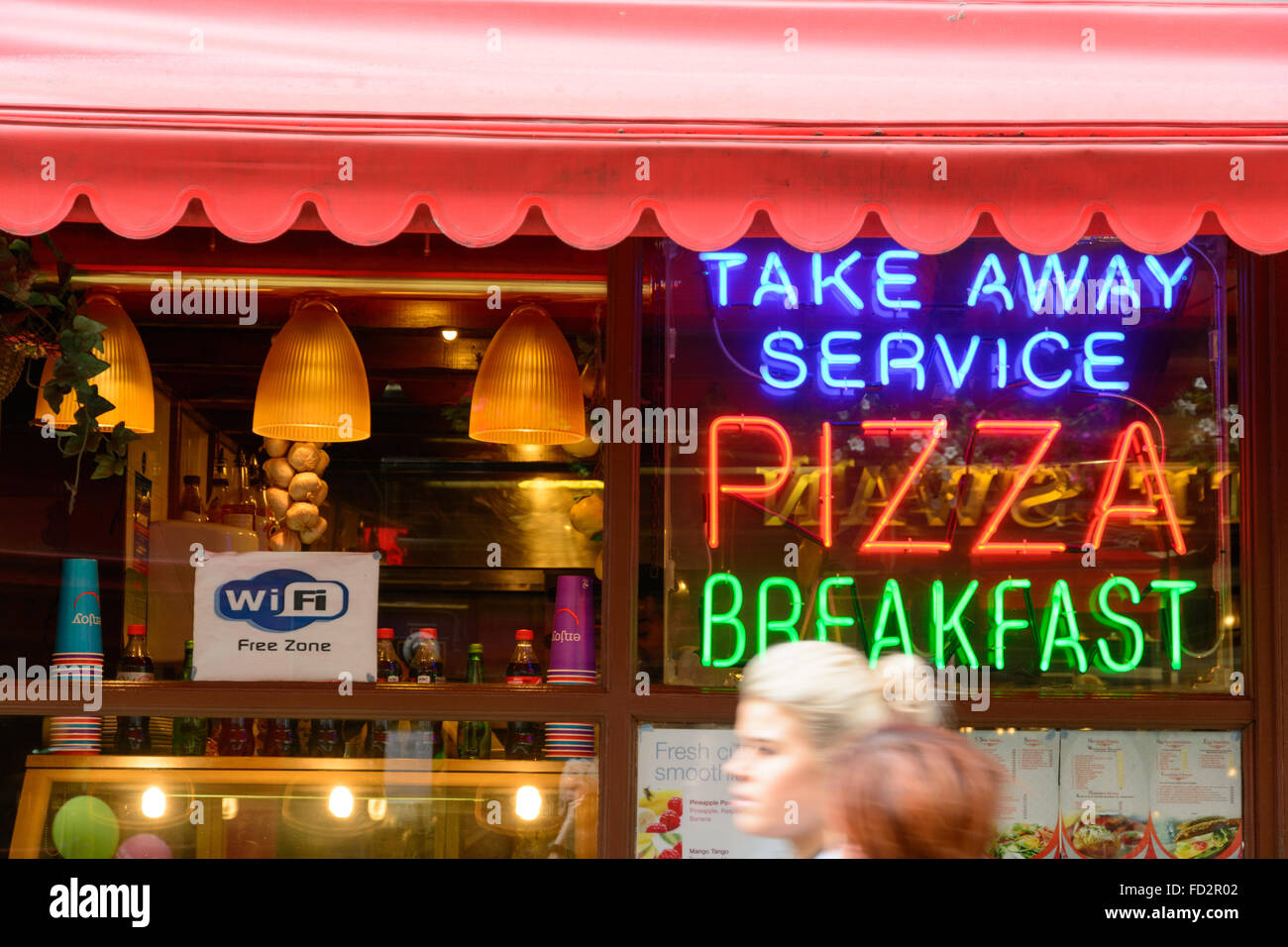 Take away Pizza restaurant with free Wi-Fi and hurrying people Stock Photo