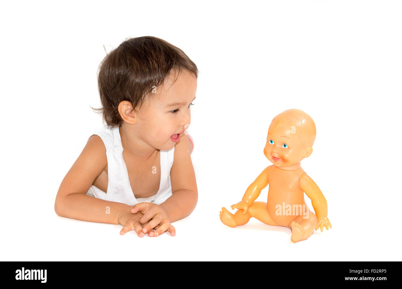 little girl playing with her doll in studio Stock Photo - Alamy