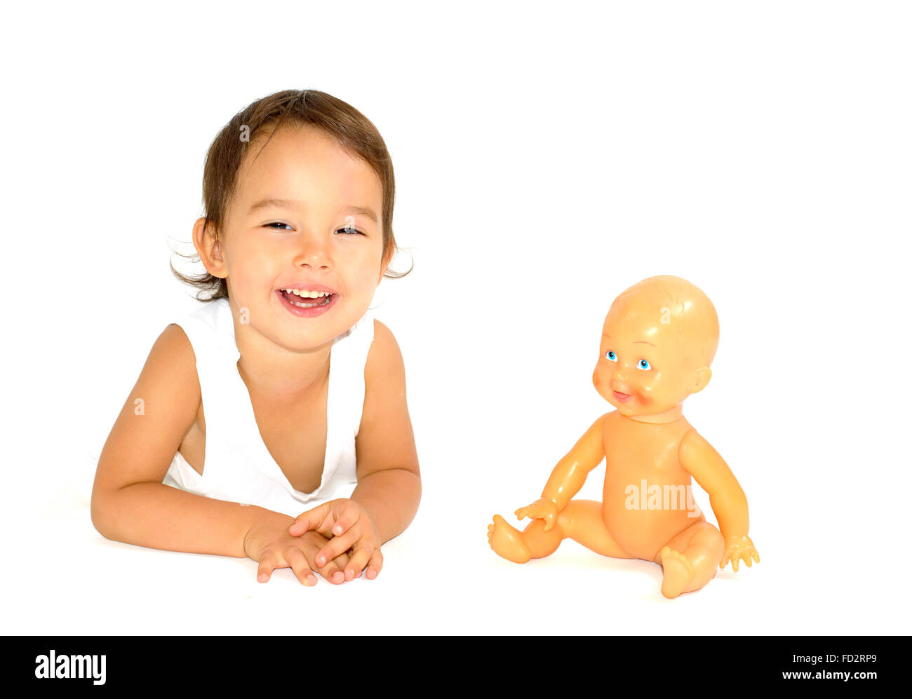 little girl playing with her doll in studio Stock Photo - Alamy