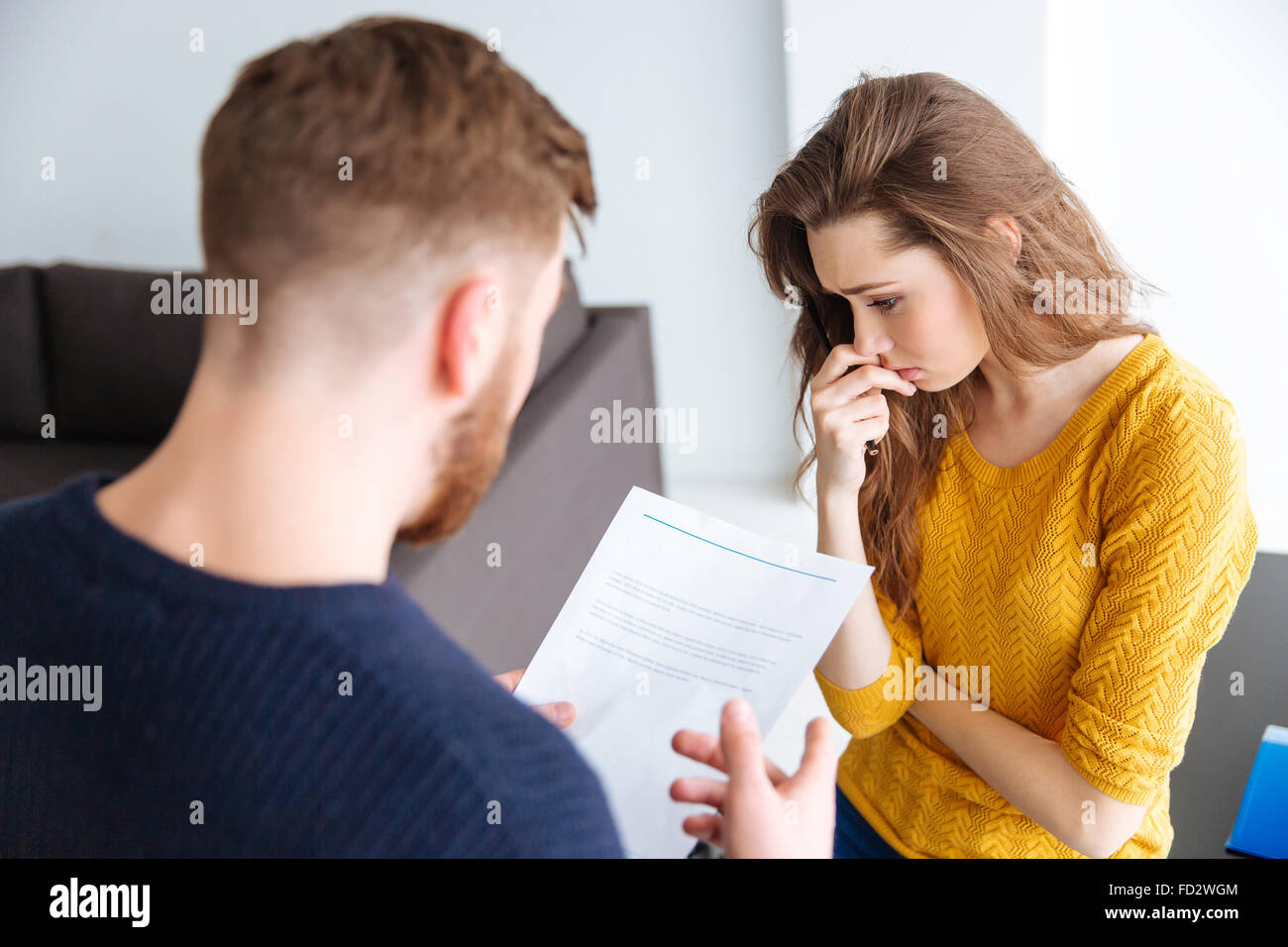 Worried couple discussing about domestic finances at home Stock Photo