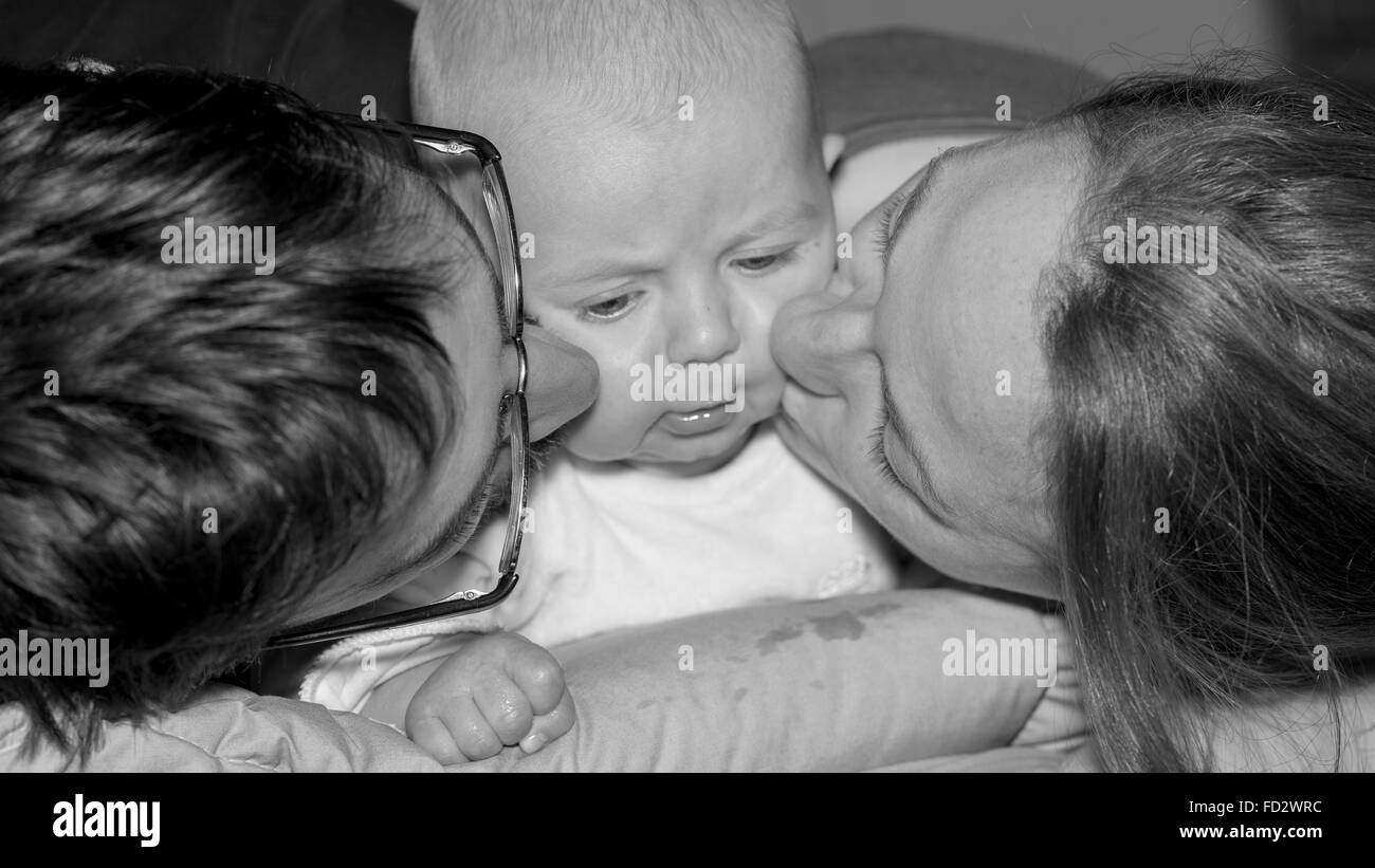 Happy and smiling portrait of Young Parents With Their Baby boy 4 month old Concept happy family Stock Photo