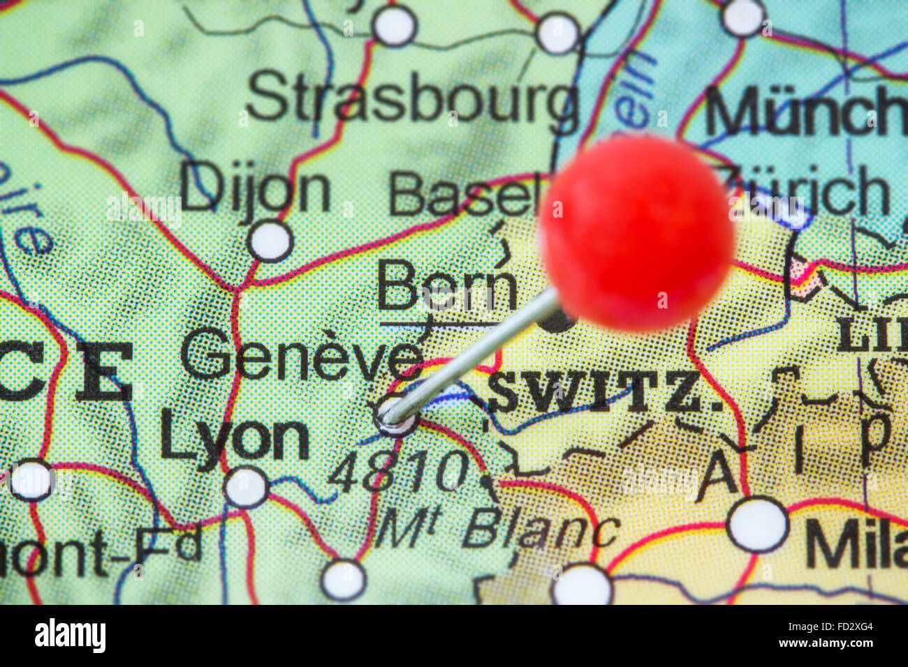 Close-up of a red pushpin in a map of Geneve, Switzerland. Stock Photo