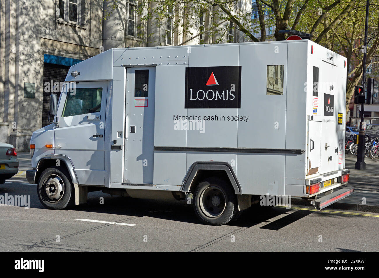 Side view of Loomis cash & valuables transport business company operating high security armoured van London England UK Stock Photo