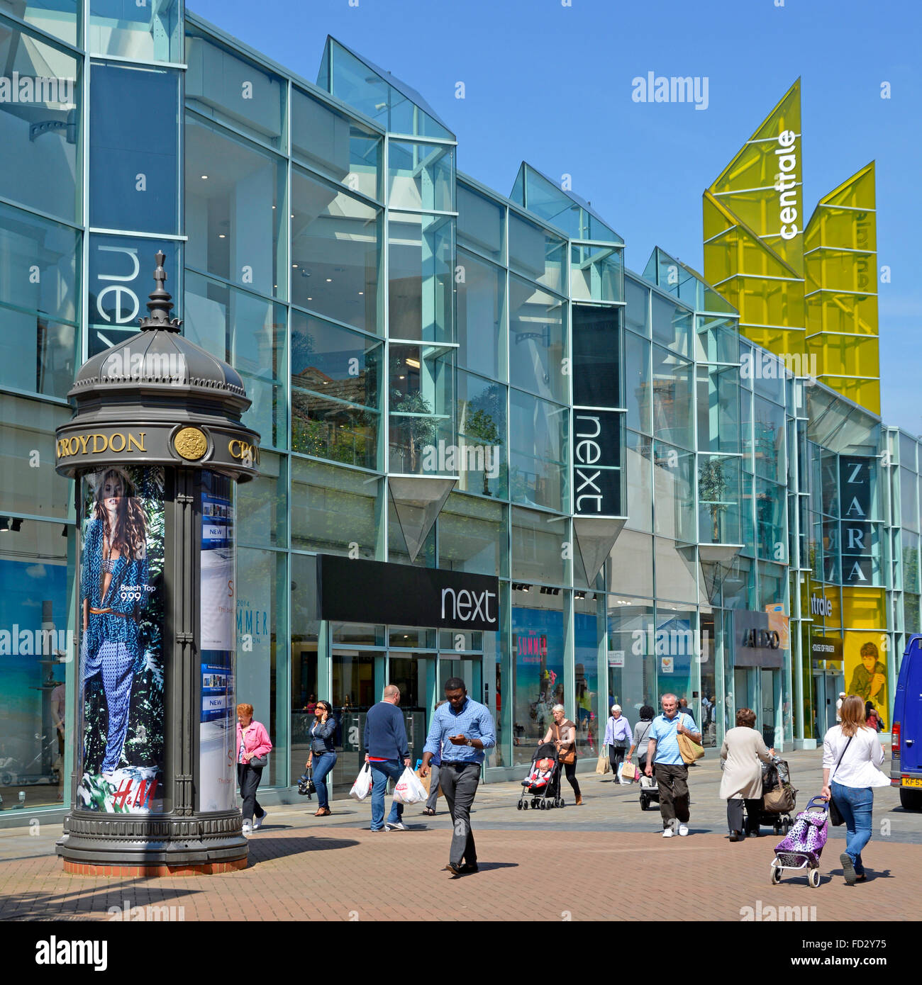 Summer shoppers in Croydon town centre pedestrianised shopping street with large Next retail business shop store building in South London England UK Stock Photo