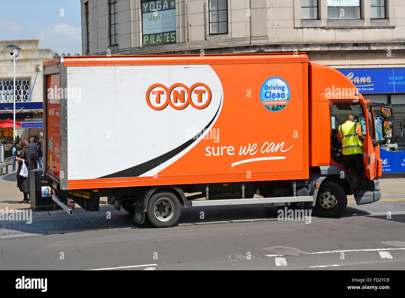 TNT 'Driving Clean' delivery van and driver parked in Wimbledon London to make a delivery Stock Photo