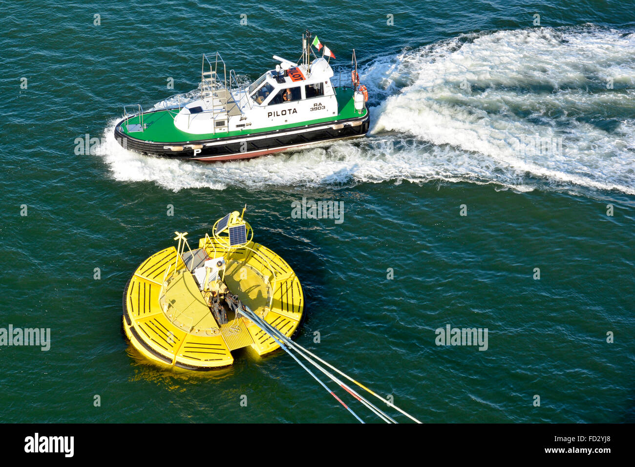 Pilot motorboat & cruise ship ocean liner hawsers fixed to Floatex floating anchor buoy anchored to sea bed fitted with solar panel Ravenna Italy Stock Photo
