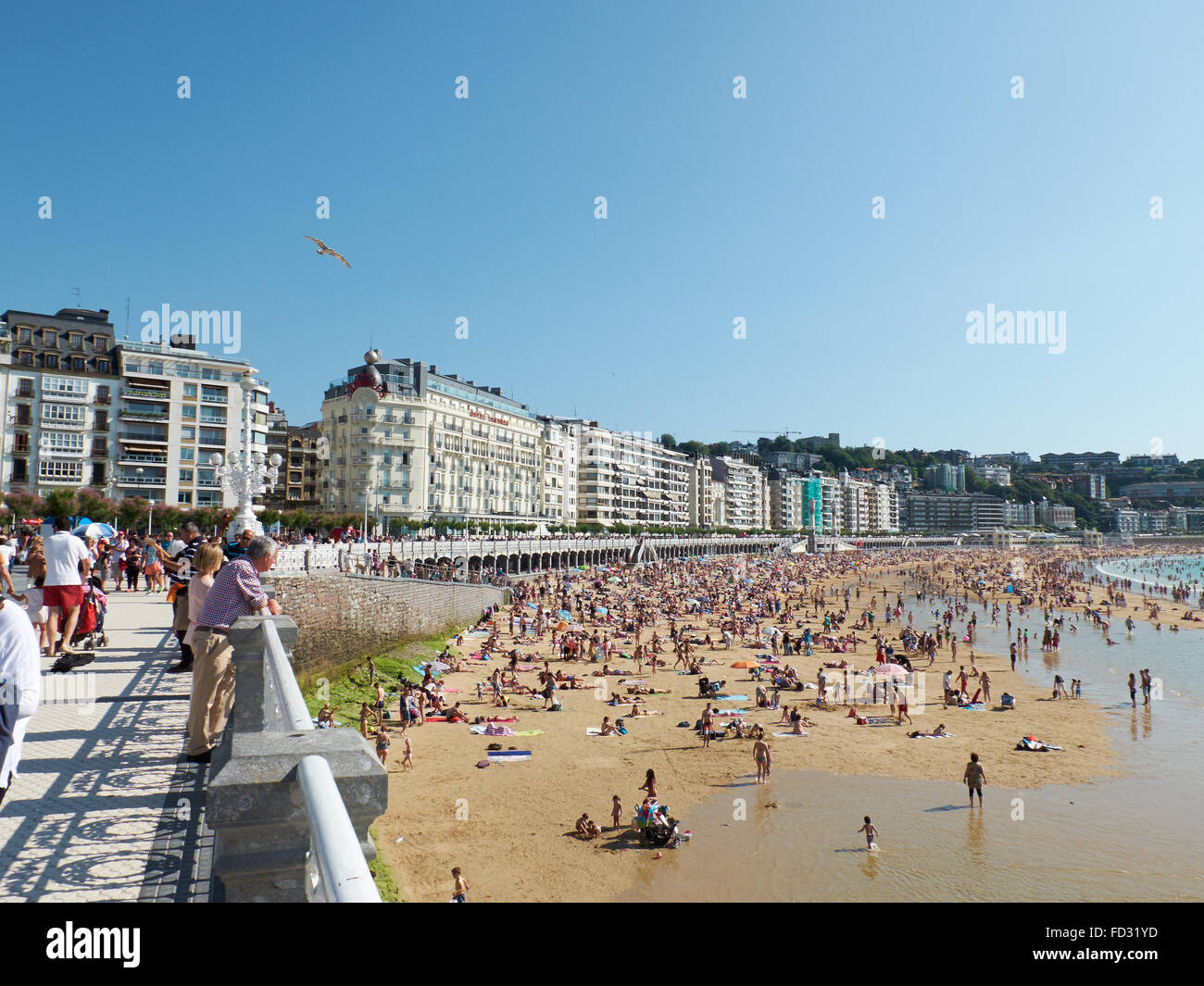 People enjoying a sunny day in Concha beach in Concha bay. San Sebastian (Donostia), Basque Country. Spain Stock Photo