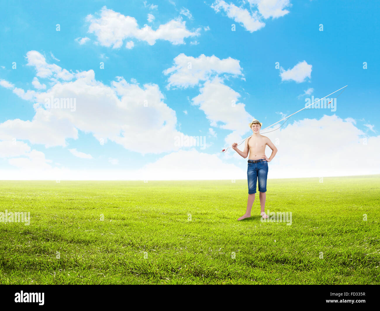 Young boy with fishing rod on shoulder Stock Photo - Alamy