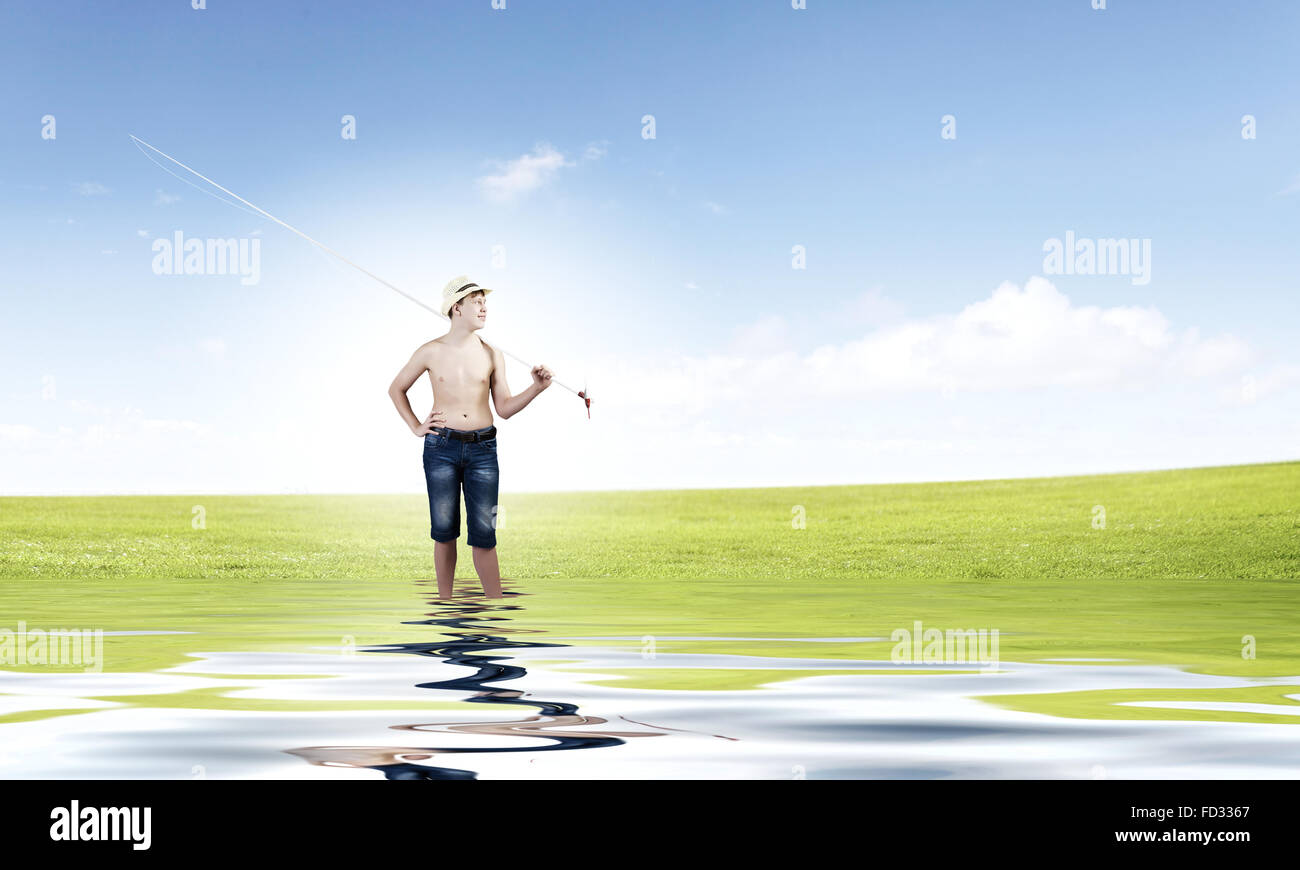 Young boy with fishing rod on shoulder Stock Photo - Alamy