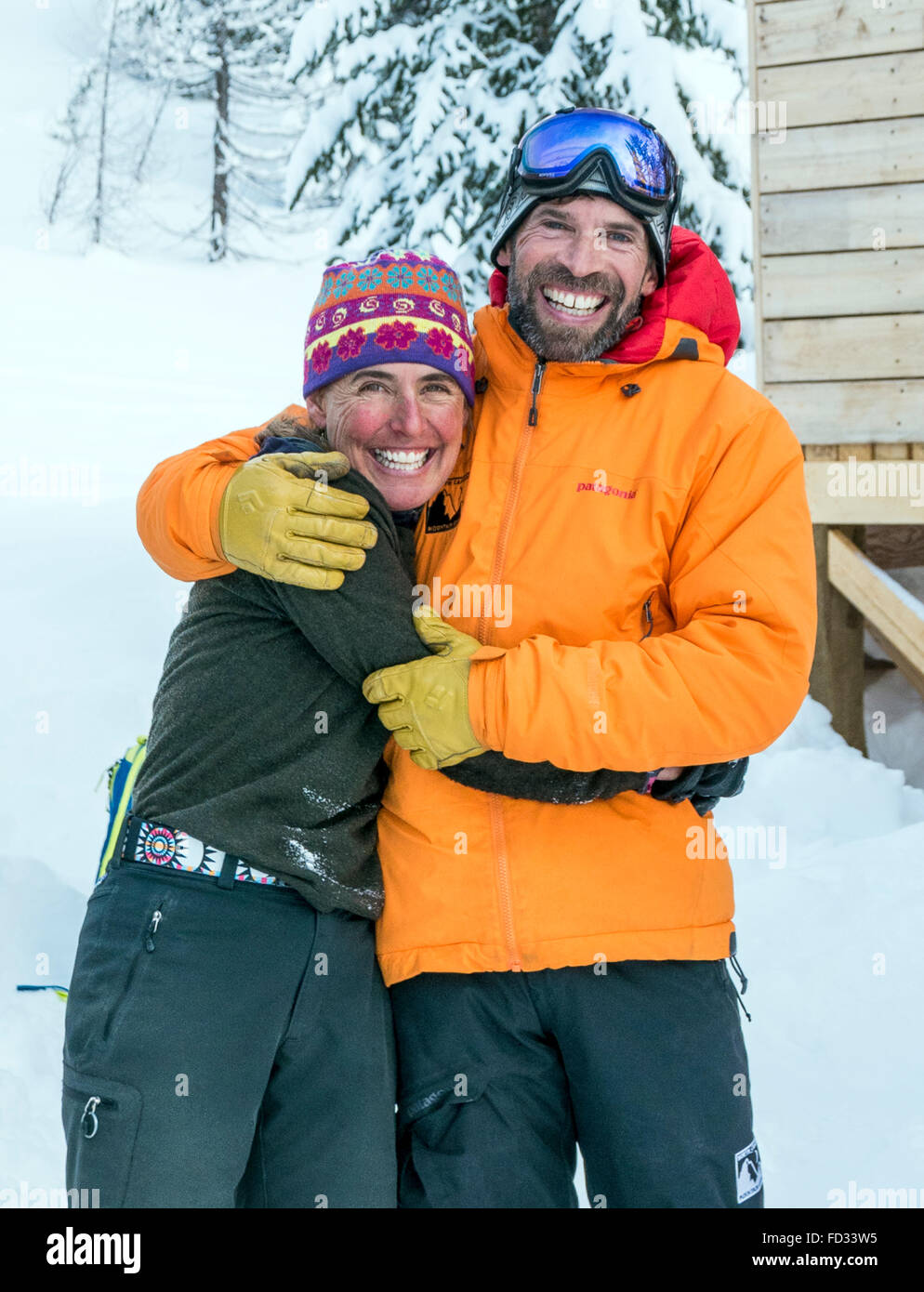Male & female backcountry skiers pose for photograph at remote Mount Carlyle Lodge; Selkirk Mountains; British Columbia; Canada Stock Photo