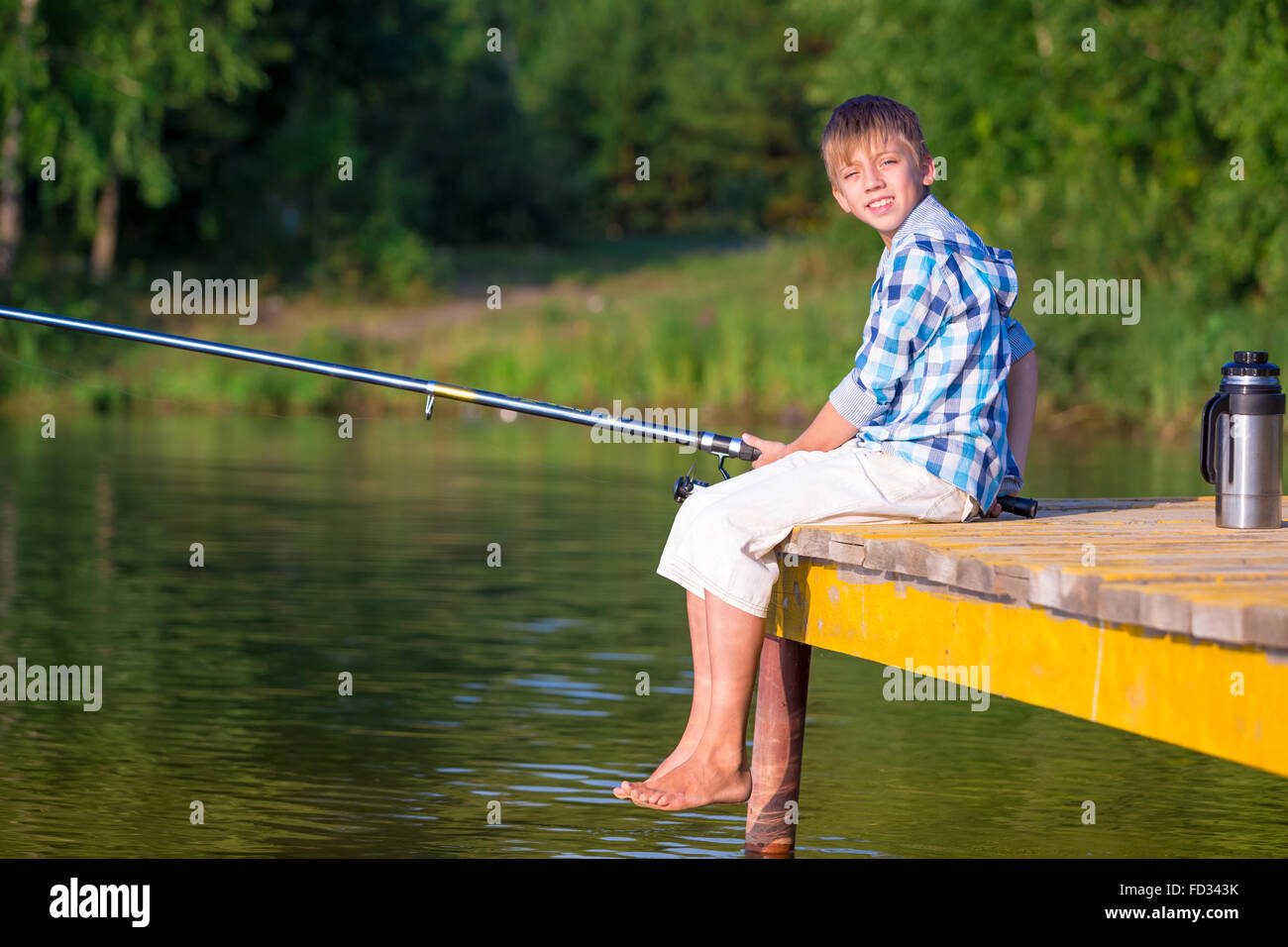 Funny Happy Little Kid Fishing on Weekend. a Fisherman Boy Stands in the  Lake with a Fishing Rod and Catches Fish. Stock Photo - Image of play,  toddler: 302837444