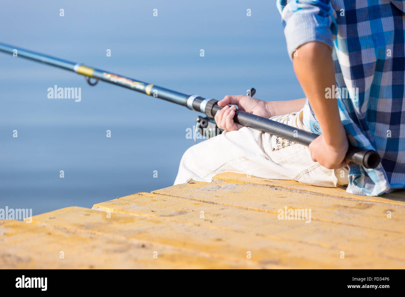 Boy holding a fishing pole hi-res stock photography and images - Page 2 -  Alamy