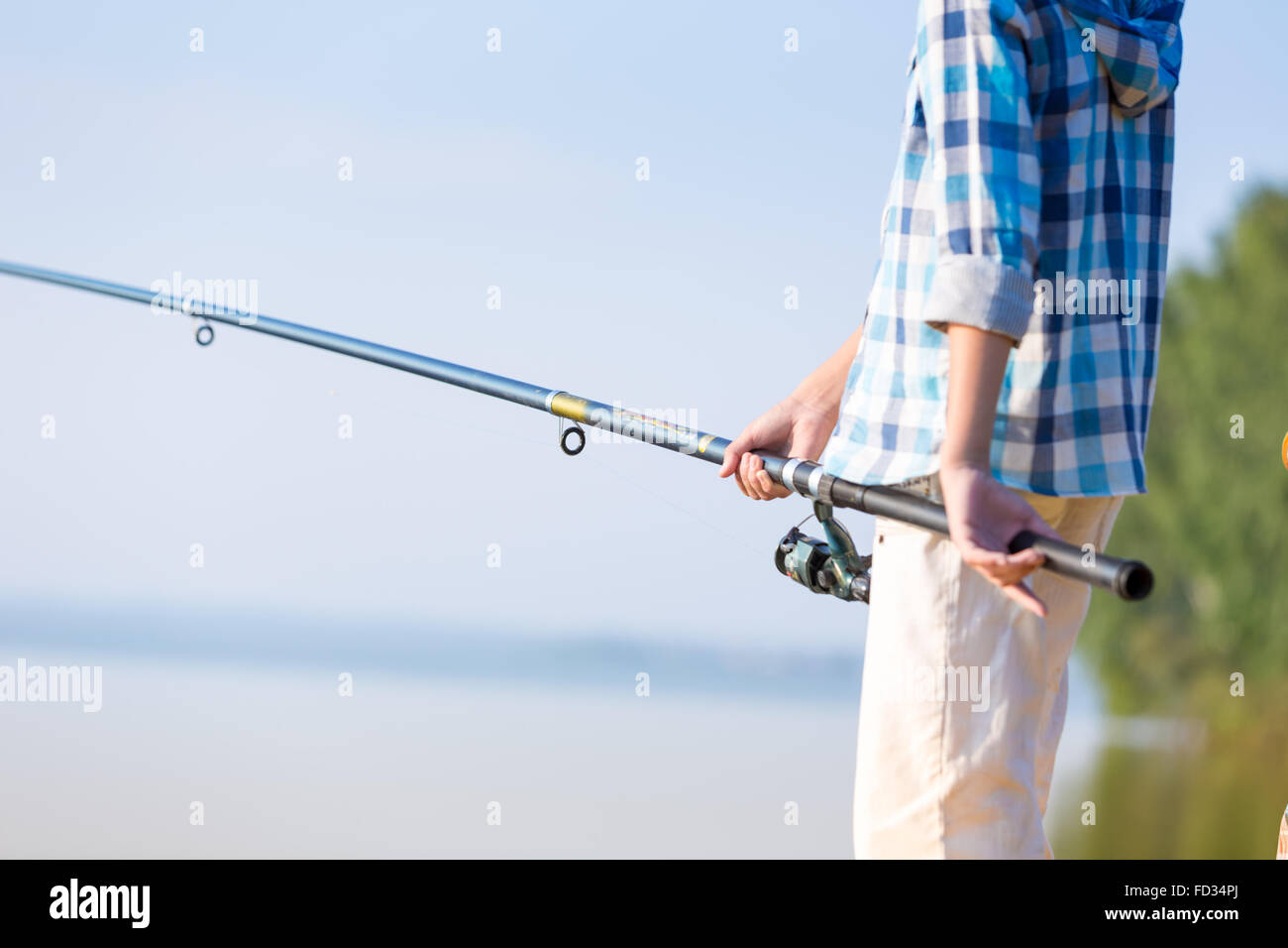 Boy holding a fishing pole hi-res stock photography and images