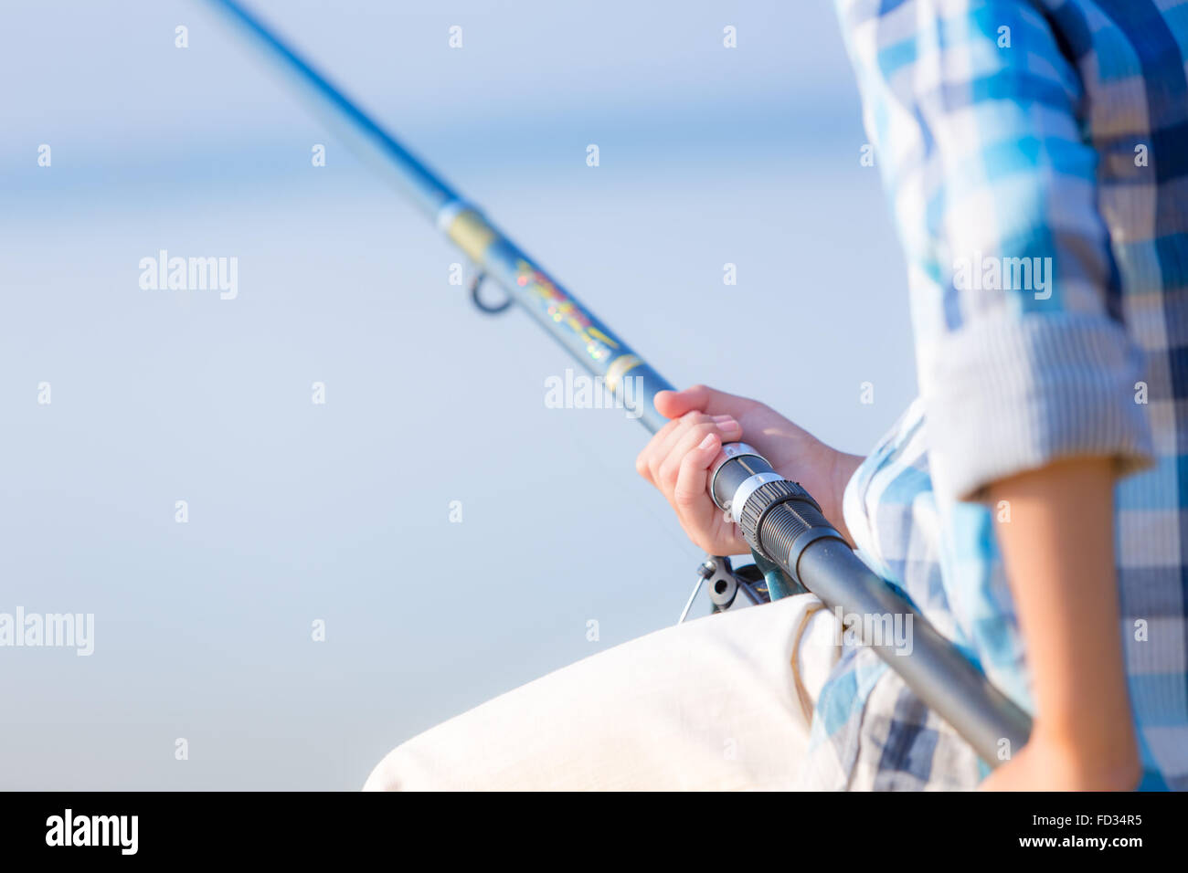 Boy holding a fishing pole hi-res stock photography and images
