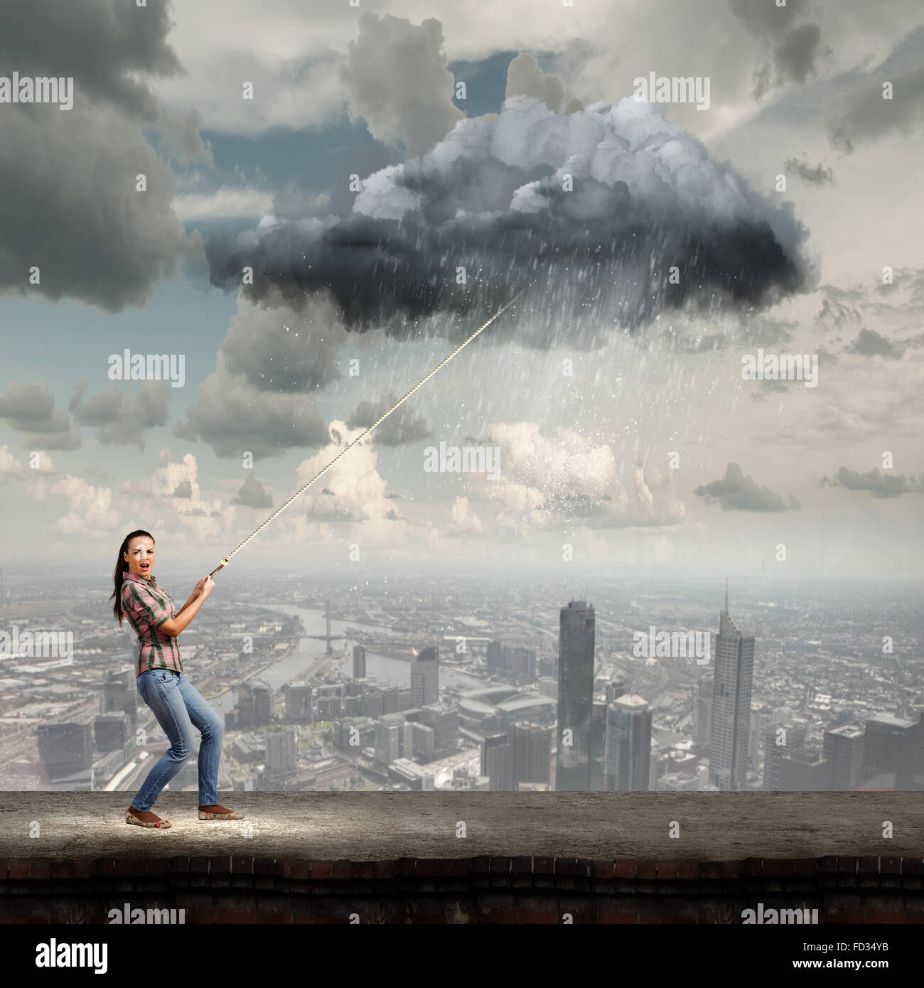Young woman in casual catching cloud with rope Stock Photo - Alamy