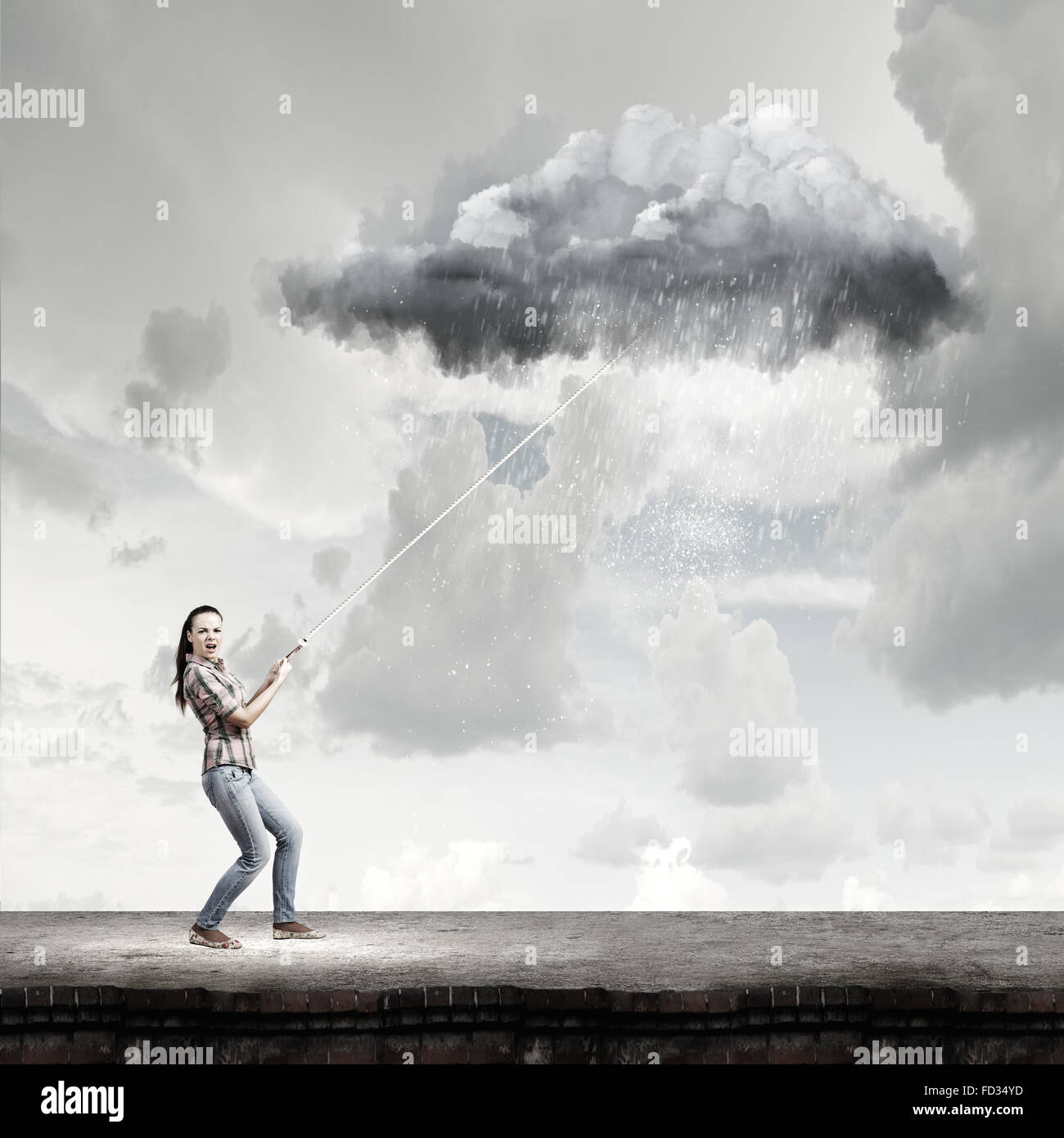 Young woman in casual catching cloud with rope Stock Photo - Alamy