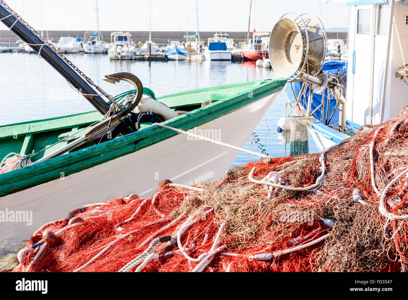https://c8.alamy.com/comp/FD3547/red-fishing-on-pier-and-on-the-boat-fishing-net-and-boats-waiting-FD3547.jpg