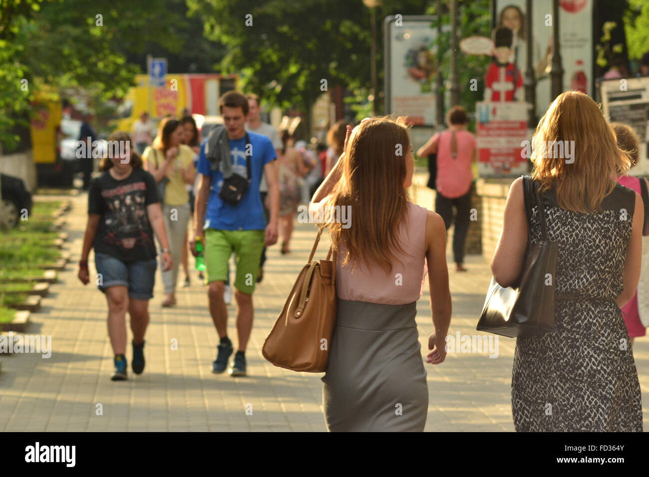 Young people walking down the street in the summer evening Stock Photo